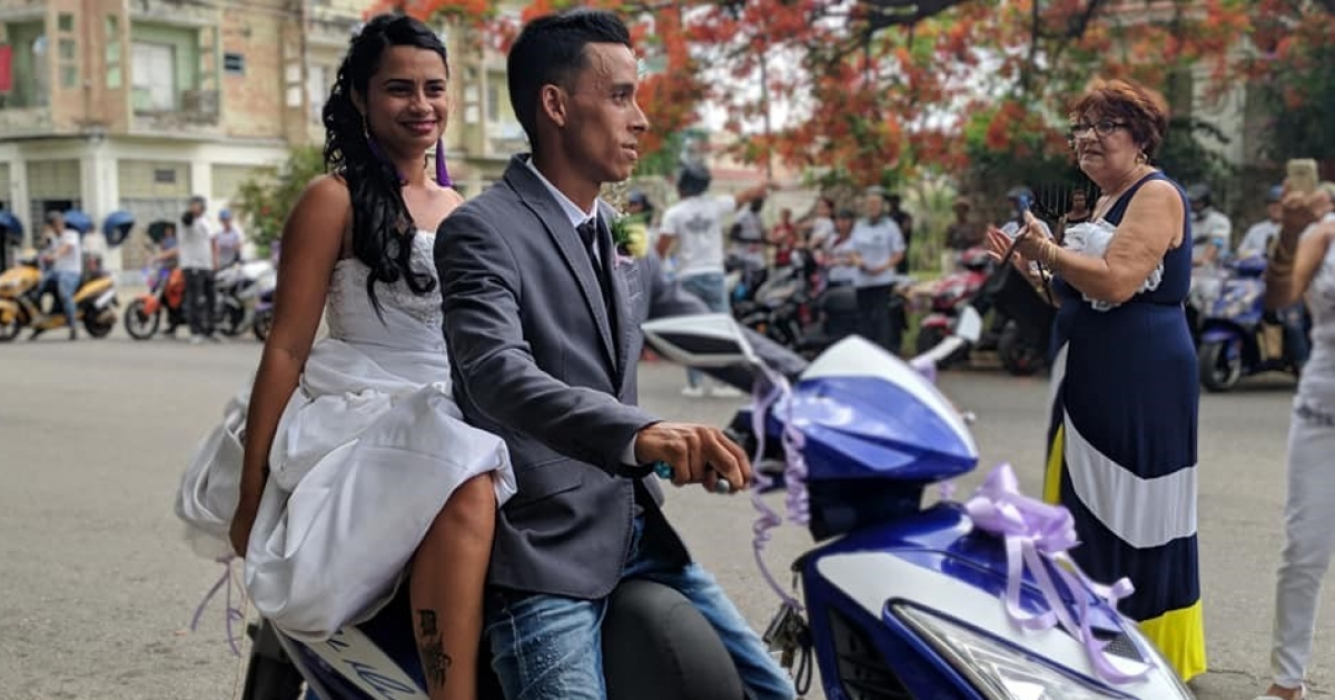 Los novios, vestidos de gala, sobre su moto © Facebook / MOTO Eléctrica CUBA