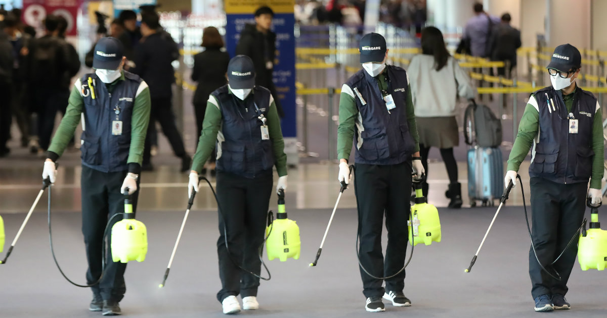 Personal provisto de mascarillas desinfecta un aeropuerto © REUTERS