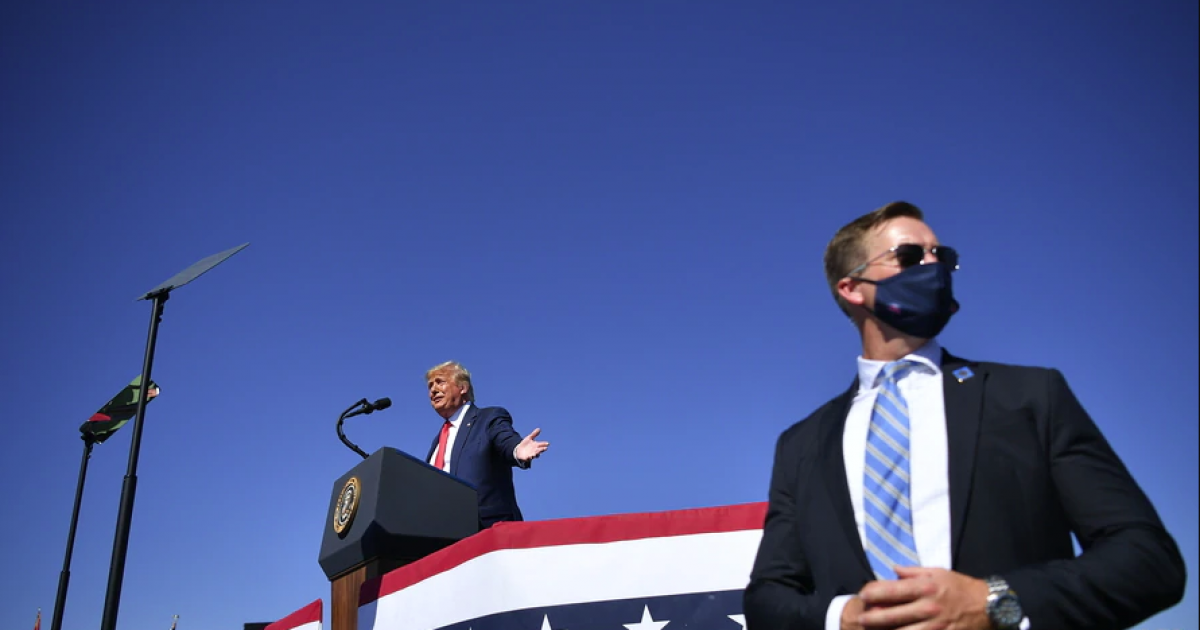 Trump y un agente del Servicio Secreto durante un mitin electoral © VOA News