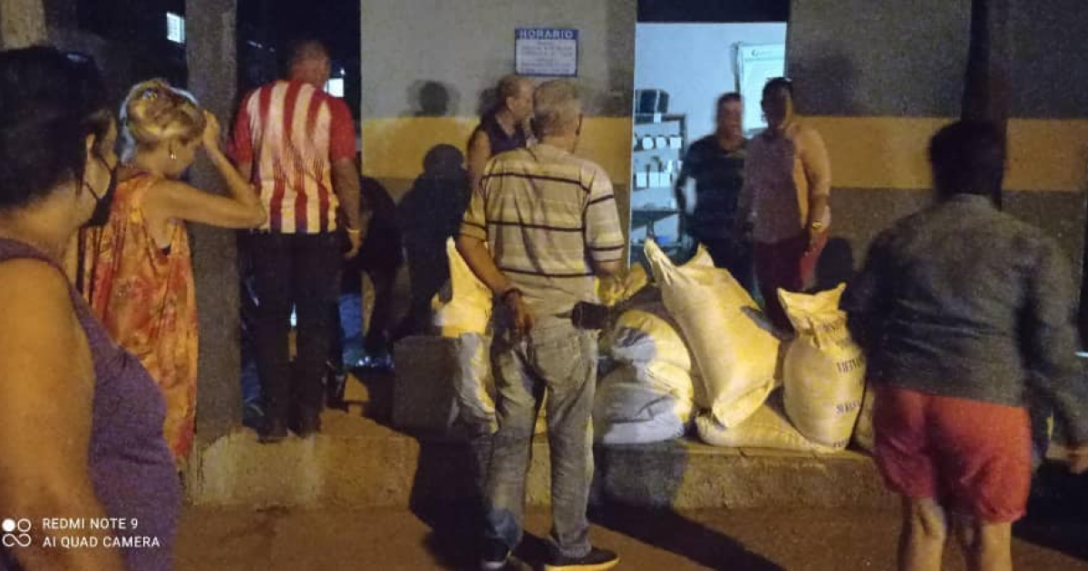 Vecinos de la bodega recibiendo los productos robados. © Facebook/Realidades desde Holguín