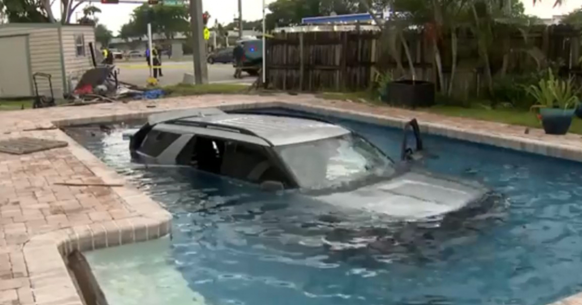 A man and a little girl trapped inside a car were rescued from a swimming pool in Florida