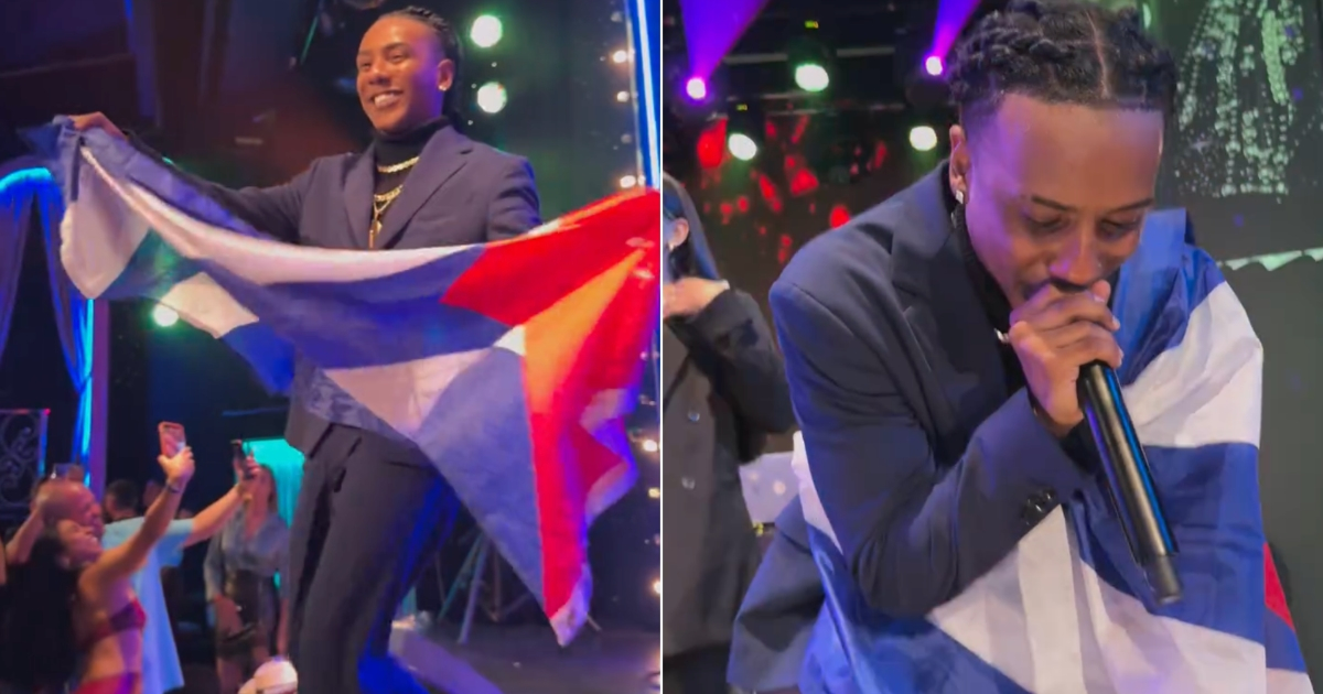 Velito El Bufón waves the Cuban flag during concert in Spain