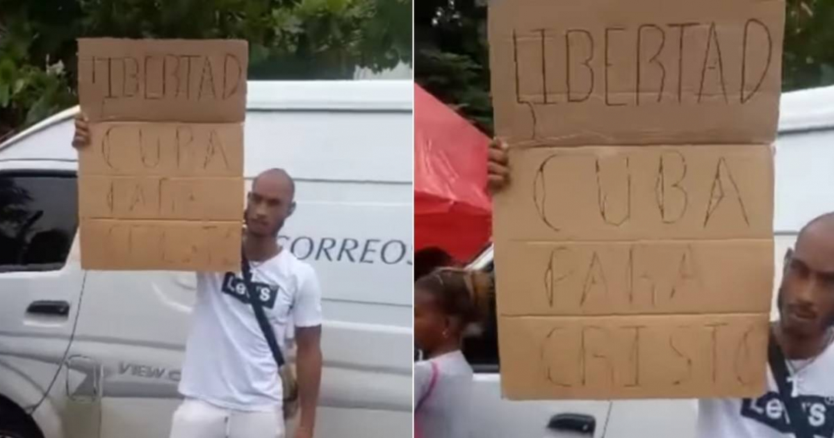 Joven cristiano alza un cartel de "Libertad" y "Cuba para Cristo" en Santiago de Cuba