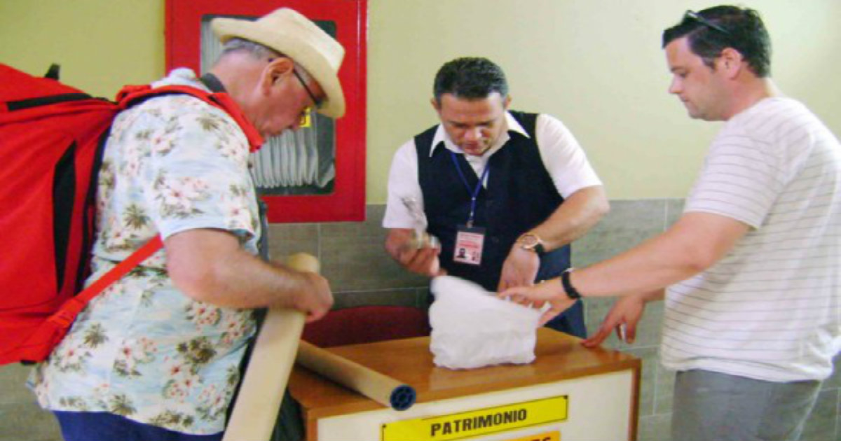 Turista ante la oficina de defensa del patrimonio en aeropuerto cubano © Registro de Bienes Culturales/Hugo García